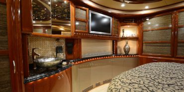 2008 Elegant Lady 889-C motorcoach interior view of bedroom shelving wall unit with TV