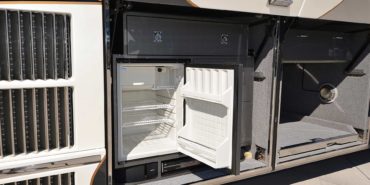 2008 Elegant Lady 889-C exterior entry side undercarriage close-up of small refrigerator outside bay of motorcoach