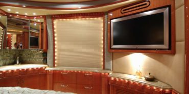 2008 Liberty Coach #892-B motorcoach interior view of bedroom shelving wall unit with TV