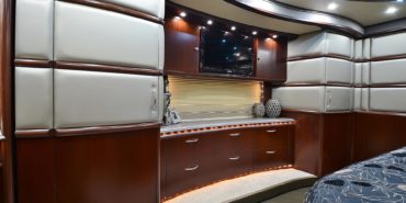 2012 Elegant Lady #7182 motorcoach interior view of bedroom shelving wall unit with TV