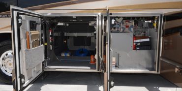2012 Elegant Lady #7182 exterior driver side undercarriage open mechanical and storage bays of motorcoach