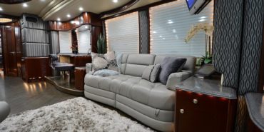 2012 Elegant Lady #7182 motorcoach interior view of side-table and sleeper sofa couch