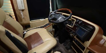 2011 Liberty Coach #5403-A motorcoach interior cockpit with driver seat and dashboard area