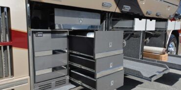 2011 Liberty Coach #5403-A exterior entry side undercarriage storage bays with pull out drawers of motorcoach