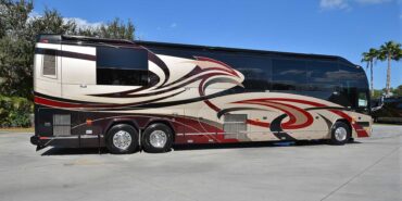 2011 Liberty Coach #5403-A exterior entry side view of motorcoach on the lot