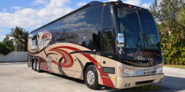 2011 Liberty Coach #5403-A exterior entry side front view of motorcoach on the lot