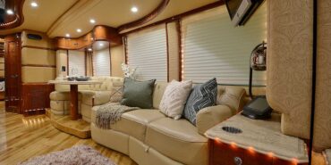 2011 Liberty Coach #5403-A motorcoach interior view of side-table and sleeper sofa couch