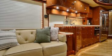 2011 Liberty Coach #5403-A motorcoach interior view of side-table and sleeper sofa couch
