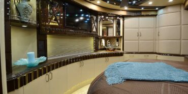 2012 Liberty Coach #5404 motorcoach interior view of bedroom shelving wall unit with TV