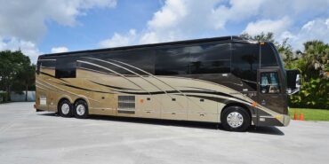 2012 Liberty Coach #5404 exterior entry side view of motorcoach on the lot