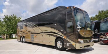 2012 Liberty Coach #5404 exterior entry side view of motorcoach on the lot