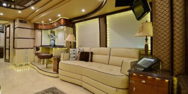 2012 Liberty Coach #5404 motorcoach interior view of side-table and sleeper sofa couch