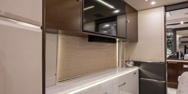 2021 Emerald #M5375 coach interior view of bedroom shelving wall unit with TV