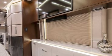 2021 Emerald #M5375 coach interior view of bedroom shelving wall unit with TV