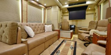2017 Emerald #M5378 motorcoach interior view of side-table and sleeper sofa couch