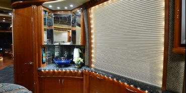 2007 Liberty Coach #M5388 motorcoach interior view of bedroom shelving wall unit with TV