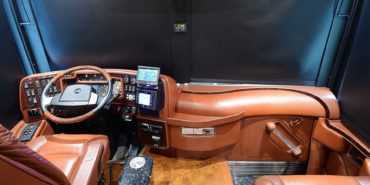2007 Liberty Coach #M5388 motorcoach interior cockpit and dashboard area from behind driver’s seat