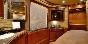 2008 Liberty Coach #M7199 motorcoach interior view of bedroom shelving wall unit with TV