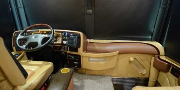2008 Liberty Coach #M7199 motorcoach interior cockpit and dashboard area from behind driver’s seat