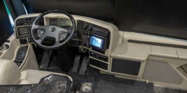 2014 Liberty Coach motorcoach interior cockpit with driver seat and dashboard area