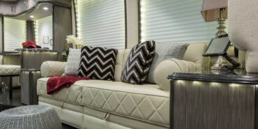 2014 Liberty Coach motorcoach interior view of side-table and sleeper sofa couch