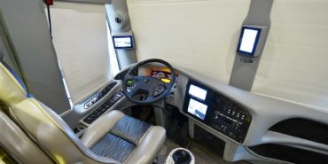 2019 Millenium #M5377 motorcoach interior cockpit and dashboard area from behind driver’s seat