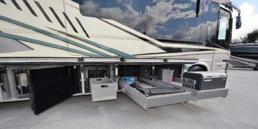 2022 Newell P50 #5391 exterior entry side undercarriage storage bays with pull out drawers of motorcoach